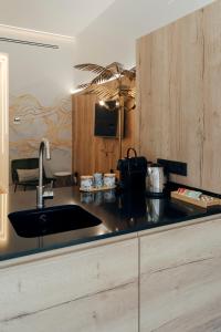 a kitchen with a sink and a counter top at Galmen Suites in Seville