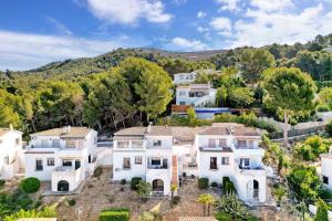 an aerial view of a large white house at Amor Supremo in Cumbre del Sol