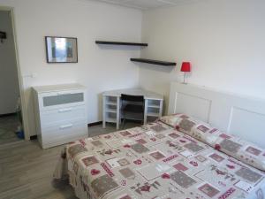 a bedroom with a bed and a desk at CASA MICHELA BB OSSOLA PARKING FREE in Domodossola