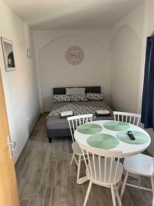 a room with a table and chairs and a bed at Music Vir Apartment in Vir