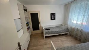 Habitación pequeña con cama y ventana en Eni en Pirot