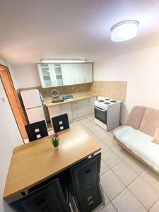 a small kitchen with a table and a couch at Apartmani Devic in Tivat