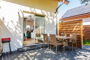 a patio with a table and chairs on a patio at Loft House Rozewie in Jastrzębia Góra