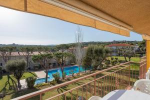 a view of the pool from the balcony of a resort at Apartamentos CASA MAREA La Fosca parking y piscina in Palamós