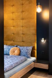 a bedroom with a bed with a wooden headboard at Golden Apartments Sokolska 30 Towers&74 in Katowice