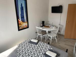 a bedroom with a bed and a table and a table and chairs at Music Vir Apartment in Vir
