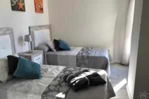 a bedroom with two beds and a couch and a mirror at Green Hills 1-2 in Orihuela