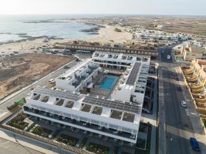 an aerial view of a building next to a beach at LACASA Apartments Cotillo in Cotillo