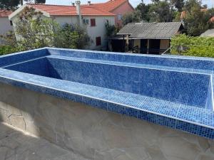 a swimming pool with blue tile on a building at Music Vir Apartment in Vir