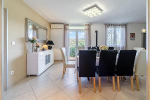 a dining room with a table and chairs at Villa Bravura in Milna