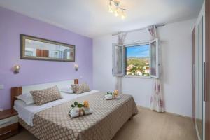a bedroom with two beds and a window at Villa Bravura in Milna +62 photos