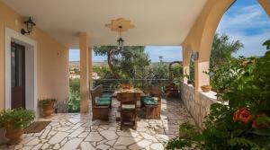 a patio with a table and chairs on a house at Villa Bravura in Milna