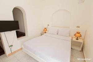 Cama ou camas em um quarto em Halomy Sharm Resort