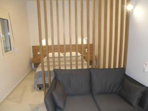 a living room with a couch and a bed at Modern lifestyle flat close to the sea. in Gázion