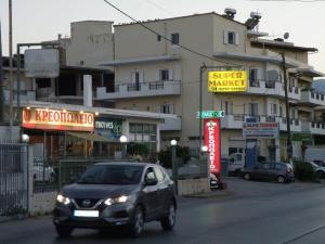 a car driving down a city street with buildings at Modern lifestyle flat close to the sea. in Gázion