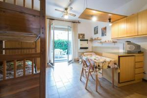 a kitchen with a table and a dining room at Casa al mare Santo Stefano al Mare in Santo Stefano al Mare