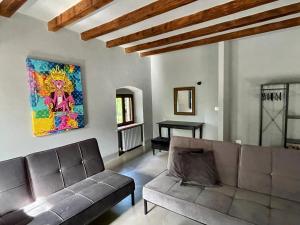a living room with a couch and a painting on the wall at Guesthouse Corte Marzago - adults friendly in Salionze