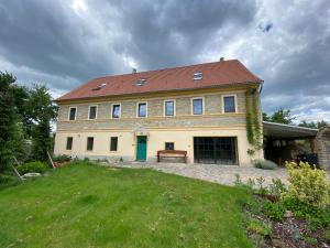 una gran casa amarilla con techo rojo en Horní Strakův mlýn, en Úštěk