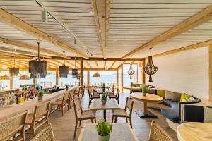 a restaurant with tables and chairs and a bar at Skiathos Thalassa Cape Hotel, Philian Hotels and Resorts in Megali Ammos +69 photos