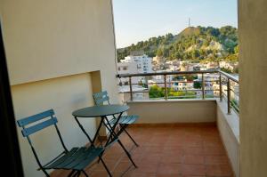 einen Balkon mit 2 Stühlen und einem Tisch in der Unterkunft Lovely 2 bedroom condo with free parking in Vlorë
