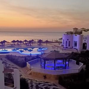 a view of a resort with a pool and the ocean at Halomy Sharm Resort in Sharm El Sheikh