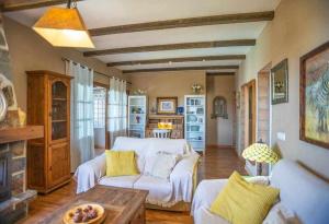 a living room with a white couch and a fireplace at La Casa Roja Torrox 6 huéspedes y piscina privada in Torrox