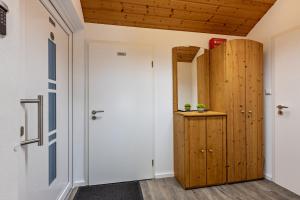 a room with a door and a wooden cabinet at Dück in Stühlingen