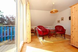 Zimmer mit einem Tisch und Stühlen sowie einem Balkon in der Unterkunft Ferienhaus Uli in Wustrow