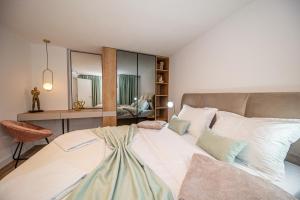 a bedroom with a large white bed and a desk at N&N Lux Guest house in Bar