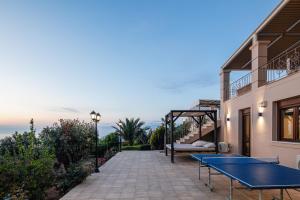 a ping pong table on the patio of a house at Villa Golden Hill in Chania Town