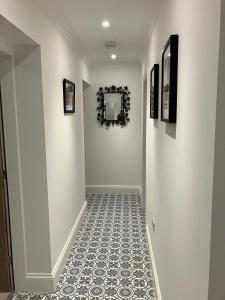 a hallway with white walls and a tile floor at HomeForYou - Holiday Home in the Wolds in Spilsby