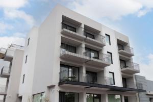 a white building with balconies on the side of it at 11Suites in Aigio