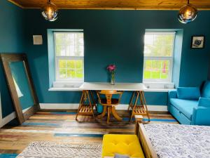 a blue room with a table and a couch at Fortwilliam Farm T12DNN2 in Cork