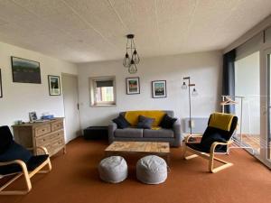 a living room with a couch and chairs and a table at Appartement 50m2 vue imprenable avec garage draps et serviettes compris in Villard-de-Lans