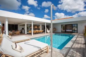a villa with a swimming pool and a patio at LXRY VILLA's in Jan Thiel