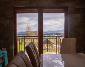 a room with a table and chairs and a window at Villa Das Zabljak in Žabljak