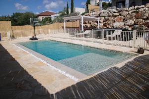 a swimming pool with a water fountain in a yard at Habait ba Shomera in Shomera