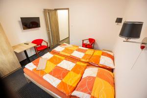 a bedroom with a bed and a table and chairs at Hotel Rabbit in Trhový Štěpánov