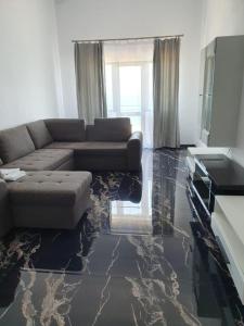 a living room with a couch and a marble floor at Seaside Inn & Suites in Costinesti