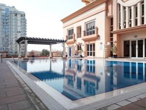 a large swimming pool next to a building at Frank Porter - Canal Residence in Dubai