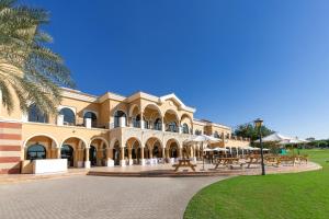 a large building with a park in front of it at Frank Porter - Canal Residence in Dubai