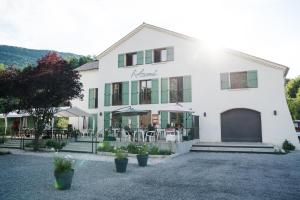 a white building with a restaurant in front of it at L’AZIMUT in Senez