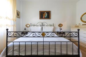 a bedroom with a black bed in a room at Villa San Donato by BarbarHouse in San Donato