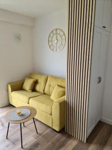 a living room with a yellow couch and a table at Apartment Mara&Padrona in Zadar