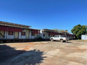 a white truck parked in front of a row of buildings at Royal Mail Hotel - Meekatharra in Meekatharra