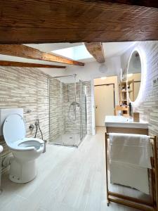 a bathroom with a toilet and a glass shower at Perfect Stay Apartments in Trieste +17 photos