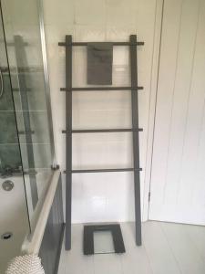 a black shelf in a bathroom with a shower at The Marches, Ludlow in Ludlow