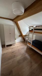 a room with a bunk bed and a desk at Rauschenbachmühle in Mildenau