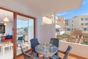 a dining room with a table and chairs on a balcony at Andaluz Apartments Mar de Nerja in Nerja