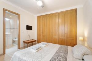 A bed or beds in a room at Las Brisas Playa San Juan